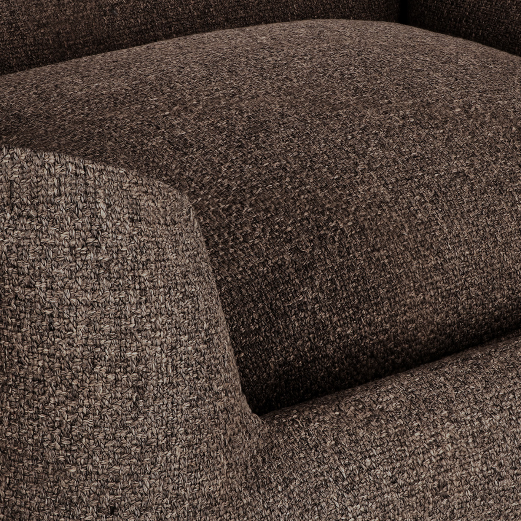 Close-up of a textured woven upholstery fabric in a dark brown and beige heathered pattern, showing the seat cushion and armrest detail.