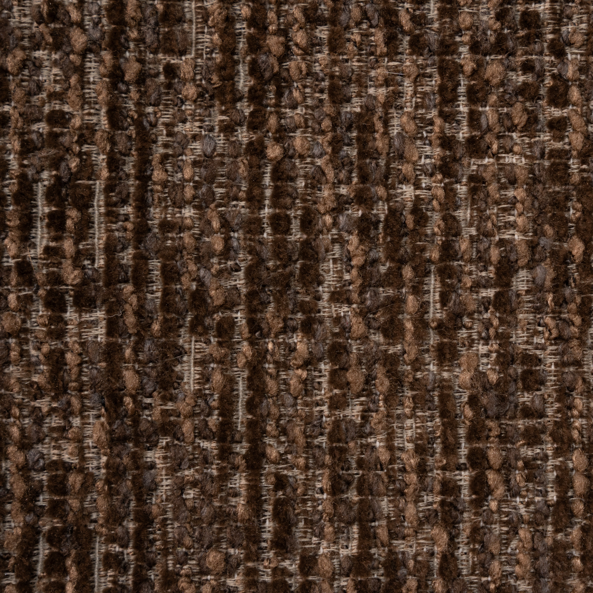 A close-up of a woven fabric texture in dark brown and tan with vertical ribbed lines.