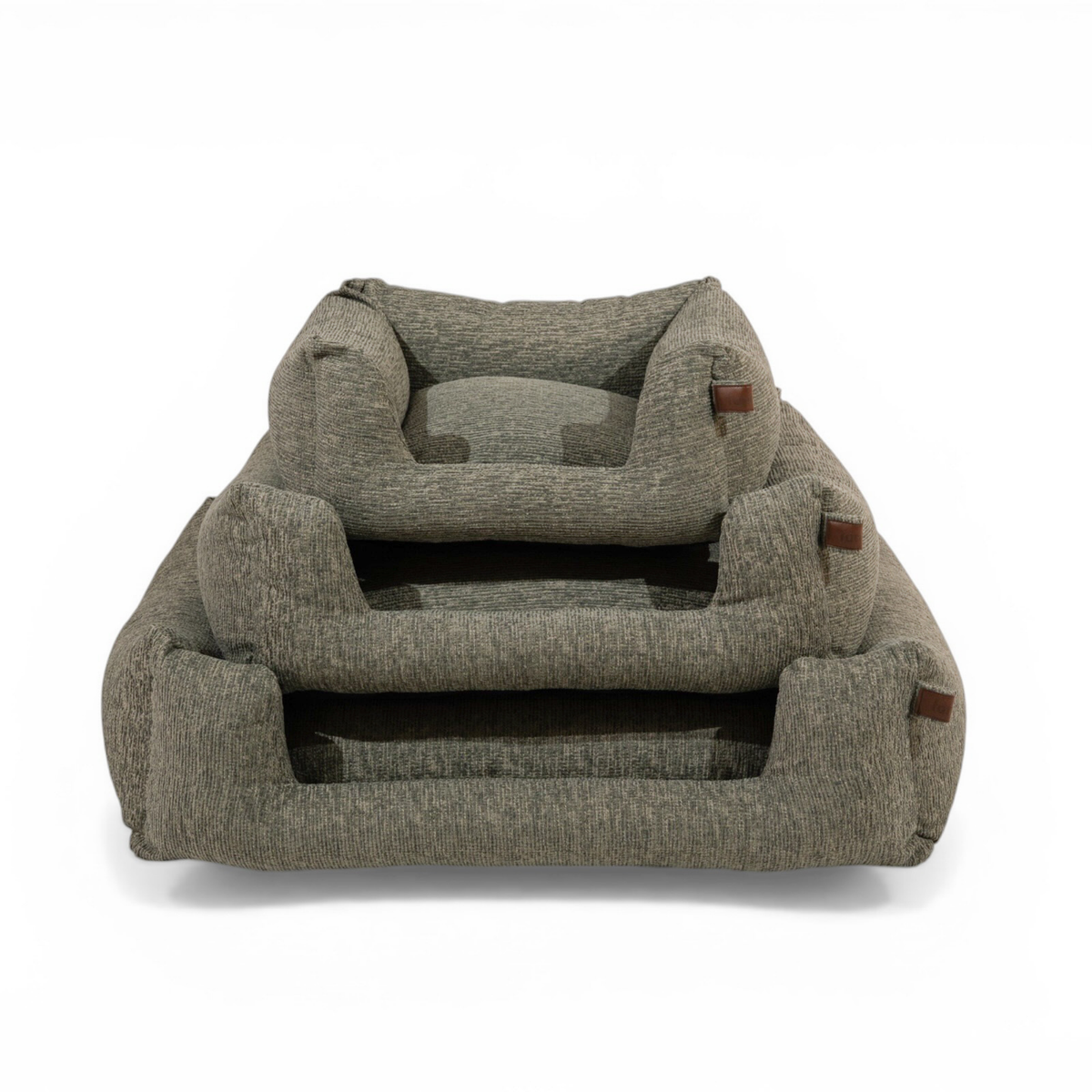A two-tiered upholstered pet bed in a textured gray fabric, featuring a small cushion on the top tier and small brown leather accents on the sides, shown against a plain white background..