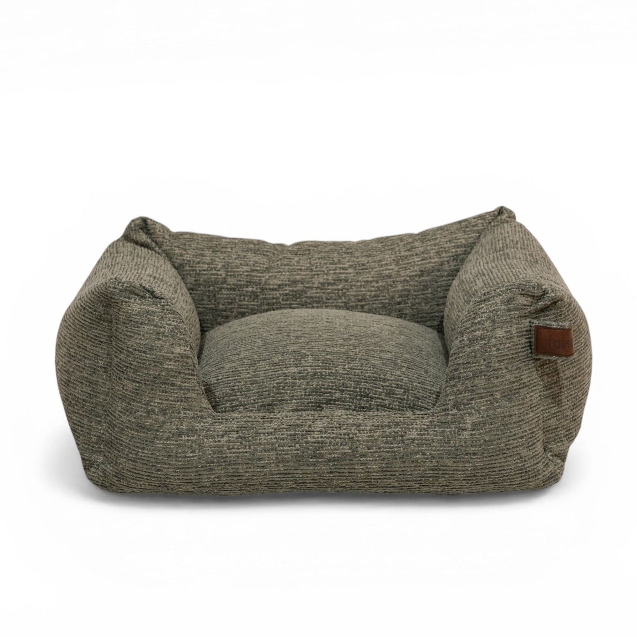 A low-profile, high-cushioned pet bed with a textured, heathered gray-brown fabric, featuring a small brown leather brand patch on the right armrest, set against a plain white background..