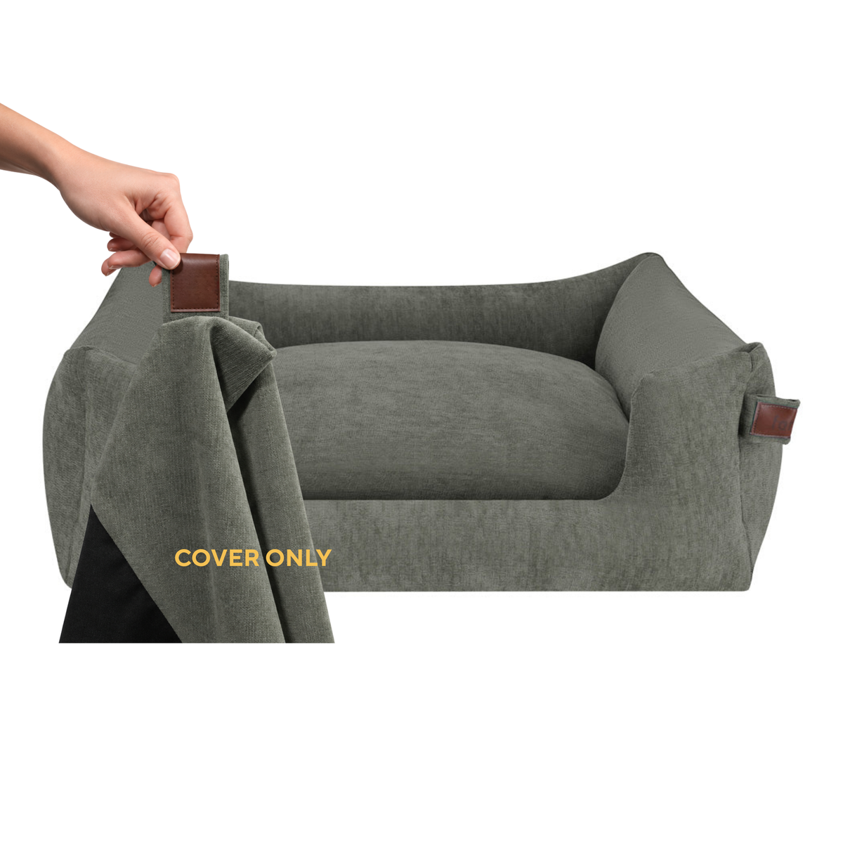 A gray upholstered pet bed with a raised cushioned interior and small brown leather tabs on the sides, shown on a white background. A human hand is lifting a matching gray cover off one side, and the words 'COVER ONLY' appear in yellow near the lower left.