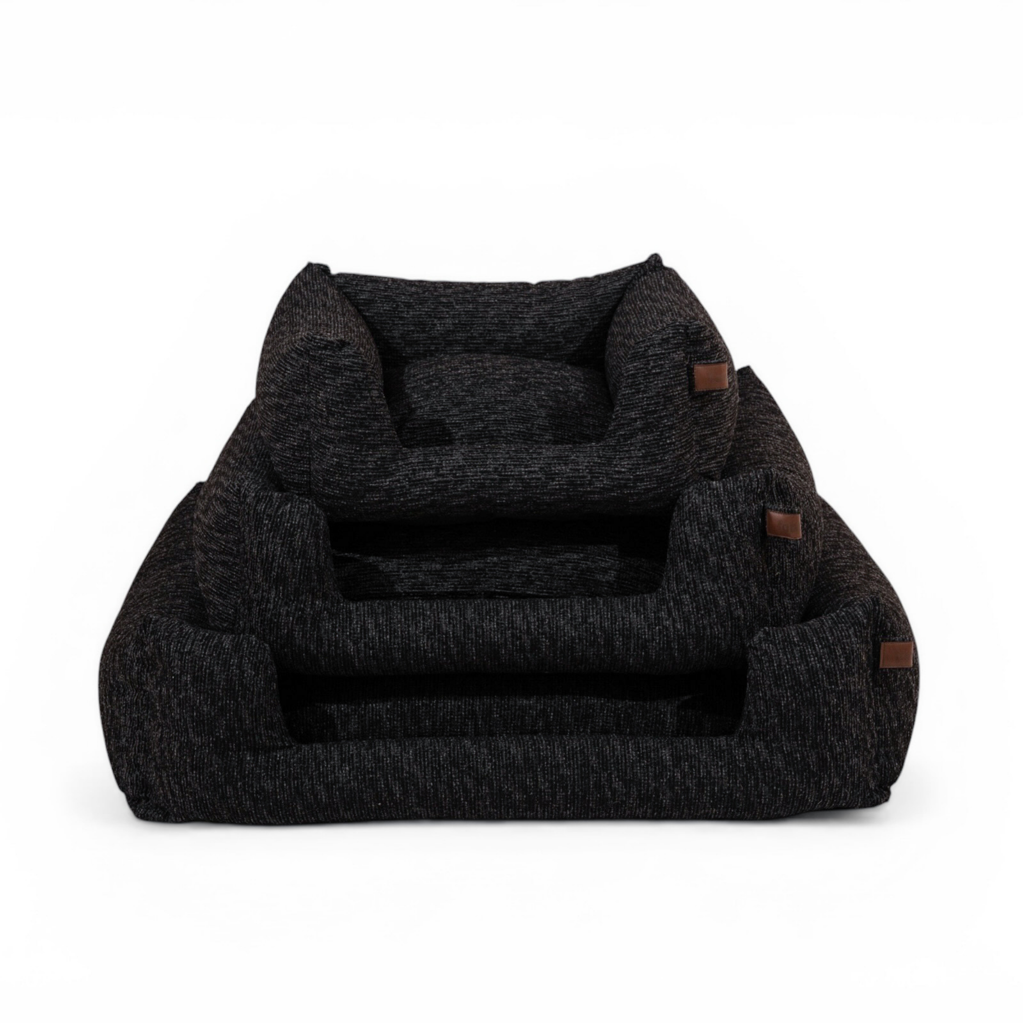 A dark charcoal gray heathered pet bed with small brown leather accents, shown on a clean white background.