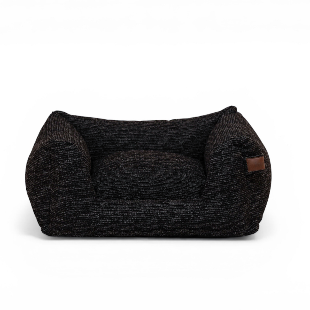 A dark charcoal gray and black textured pet bed with a small brown leather patch on the side, shown against a plain white background.
