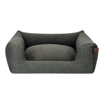 A dark gray textured fabric pet bed with a raised armchair-style design and a small brown leather brand tag on the right side, shown against a plain white background.