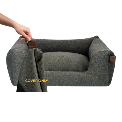 A dark gray textured pet bed with a raised armchair-style back and sides, shown on a white background. A human hand is pulling open a cover flap attached to the bed, and the words 'COVER ONLY' appear in yellow near the flap. 