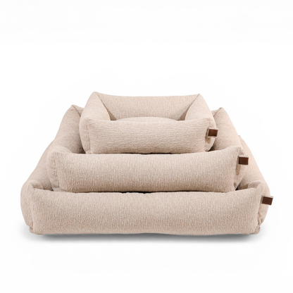 The Snug dog bed in Clay Beige in all three sizes, nested together 