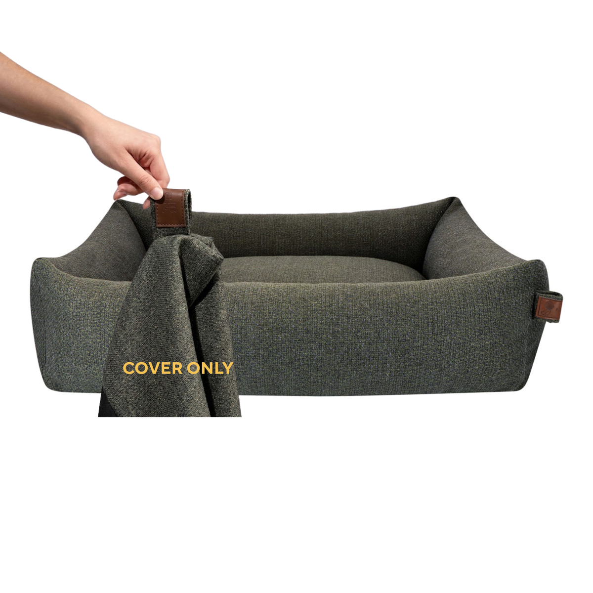 A hand lifting the removable cover off the Snug dog bed in Seaweed Green, labelled Cover only 