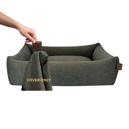 A hand lifting the removable cover off the Snug dog bed in Seaweed Green, labelled Cover only 