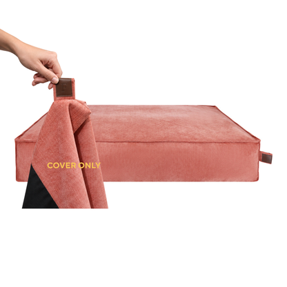 A hand lifting the removable cover off the Stargaze dog mattress in Rusty Orange, labelled Cover only 